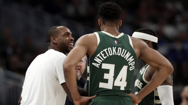 Milwaukee Bucks forward Khris Middleton talks with forward Giannis Antetokounmpo (34